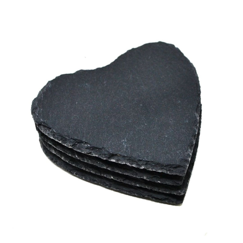 A stack of four heart-shaped black slate coasters. The edges of the coasters are rough and natural, contrasting with the smooth, flat surfaces. Perfect for table protection, these MyHomeDecor.ca s/4 Coasters Heart - Black are slightly angled to show their thickness and texture.