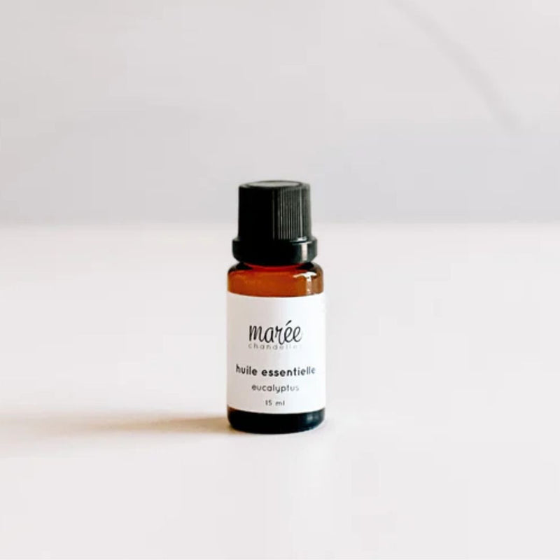 A small amber bottle with a black cap is centered against a plain background. The label reads "marée enchantée huile essentielle eucalyptus 15 ml." This Eucalyptus Essential Oil by MyHomeDecor.ca is perfect for natural air purification or as an all-purpose cleaner.