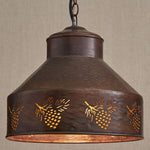 A rustic MyHomeDecor.ca Hanging Lamp - Pinecone boasts a bronze finish with intricate pinecone accents along its wide, cylindrical shade. The dark, hammered metal finish and warm amber glow from within give it a cozy, lodge-like feel. The light hangs from a sturdy chain against a neutral background.
