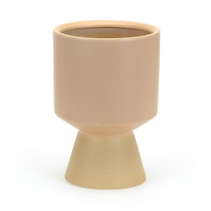 A modern tan ceramic planter with a smooth cylindrical shape sits on a speckled, matte-finished, conical base. This Tapered Pot - Beige by MyHomeDecor.ca's minimalist design showcases a two-tone effect, blending glossy and matte textures to give your house plants a stylish, contemporary touch.