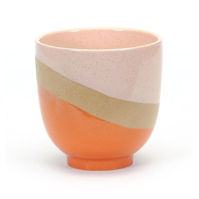A small, round ceramic cup featuring a tri-color design with speckled pink at the top, a beige middle, and a solid orange base. The colors are arranged in a diagonal stripe pattern, giving the Medium Bright Raised Base Pot - Orange/Pink/Sandstone by MyHomeDecor.ca a modern and stylish appearance, perfect for house plants or as part of your ceramic pot collection.