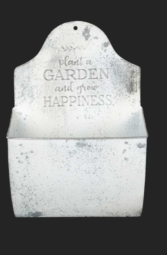 A white, antique metal wall planter with a distressed finish and a rectangular container. The back features the inscription, "Plant a GARDEN and grow HAPPINESS." This Large Antique Wall Planter - White by MyHomeDecor.ca is set against a plain black background.