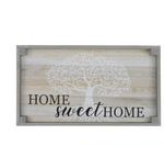 A rectangular wooden sign with a light gray frame and a whitewashed background, featuring an elegant rustic touch. In the center, there is a stylized white tree with sprawling branches. The words "HOME sweet HOME" are written in black and cursive script across the bottom, perfect as a hostess gift. This beautiful piece is known as the Small Home Sweet Home Tray - Grey by MyHomeDecor.ca.