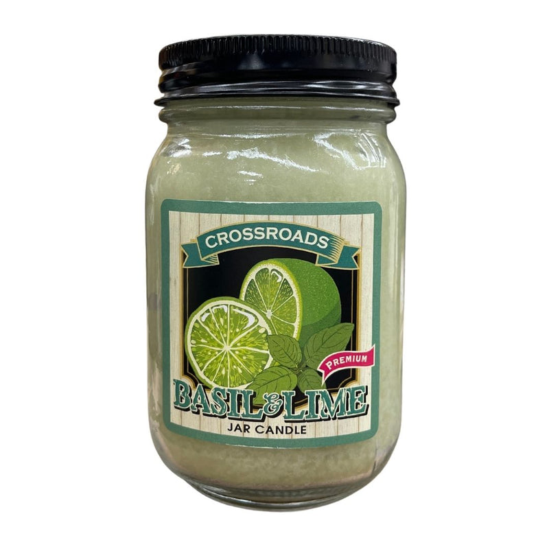 A Candle Jar - Basil Lime from MyHomeDecor.ca is shown, scented with basil and lime. The jar has a black lid and contains light green wax infused with natural essential oils. The label features images of basil leaves and lime slices with the text "Basil & Lime" prominently displayed.