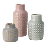 Three *MyHomeDecor.ca* Ceramic Vases - Green with 6x2 dimensions are displayed, each featuring a textured crisscross pattern. The vases vary in height and color: one tall pink, one medium green, and one shorter gray. They have a rustic, glazed finish.